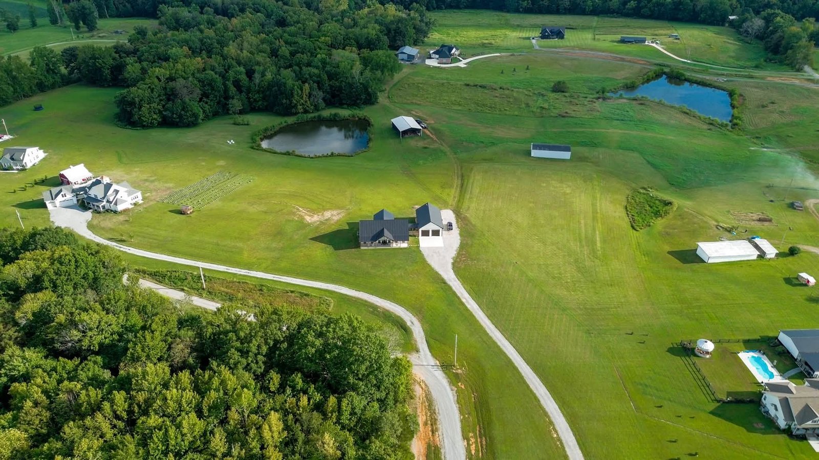 Wide aerial property view with ponds and acreage
